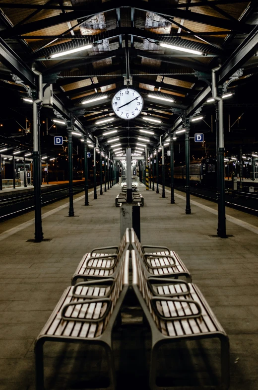 a clock sitting at the end of a walkway