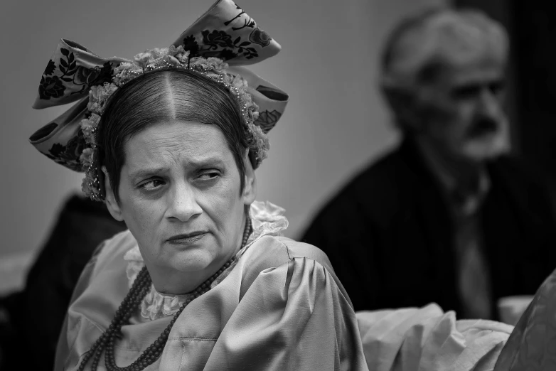 a woman with a headscarf sitting in front of two men