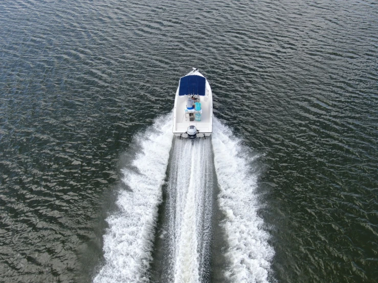 a white boat moving across the water