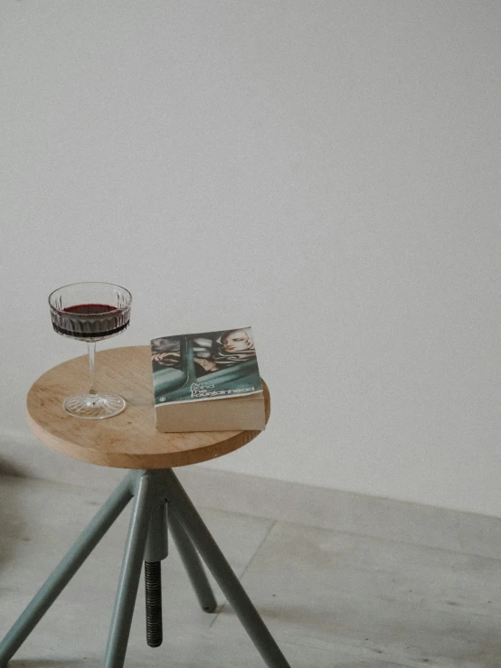 a wooden table with a glass and a wine glass on it