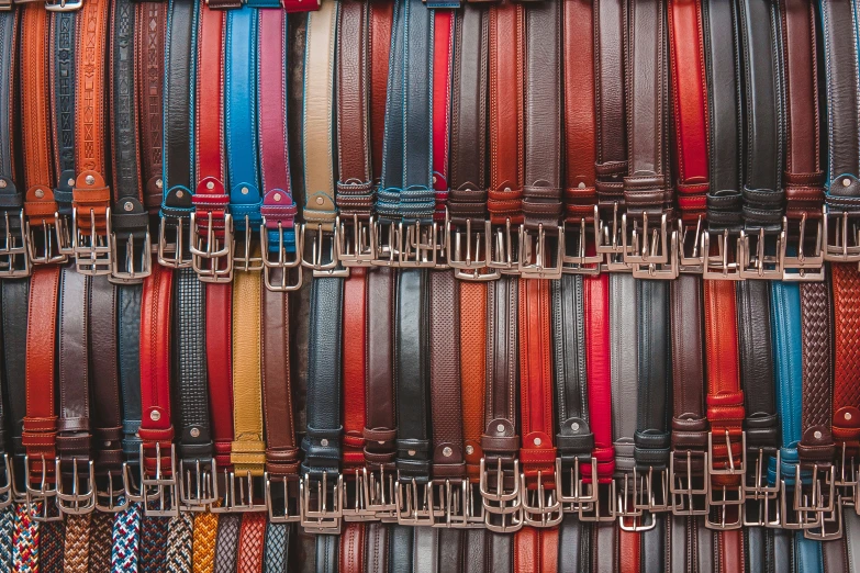 a display case with a number of different colored belts on the wall