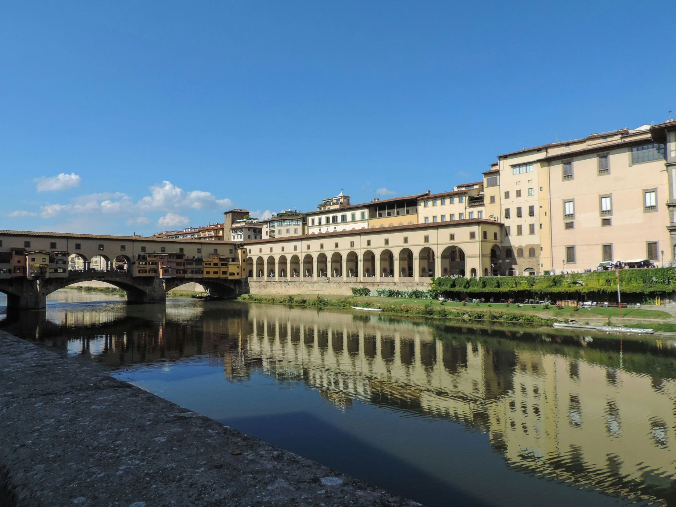 old bridge and buildings in a city, on the water