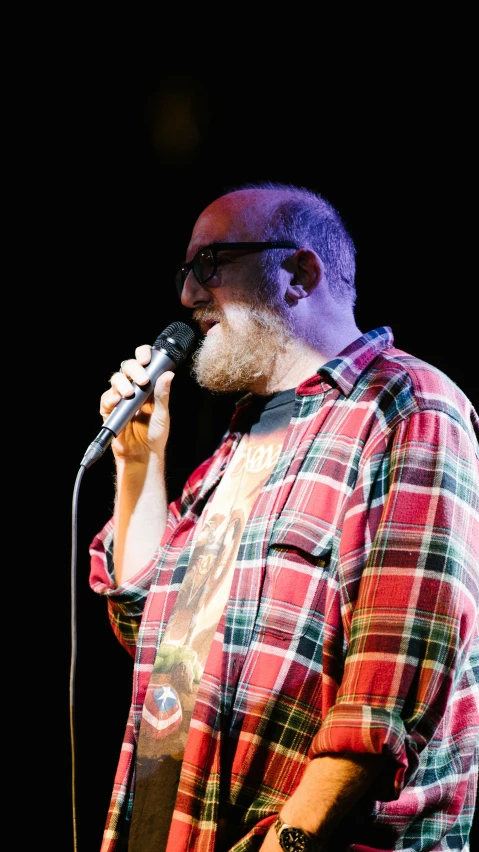 a man with a beard holding a microphone