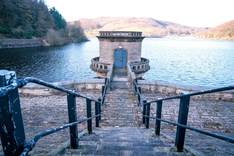 an interesting looking building with steps leading down to the water