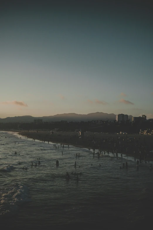 a bunch of people are playing in the ocean together