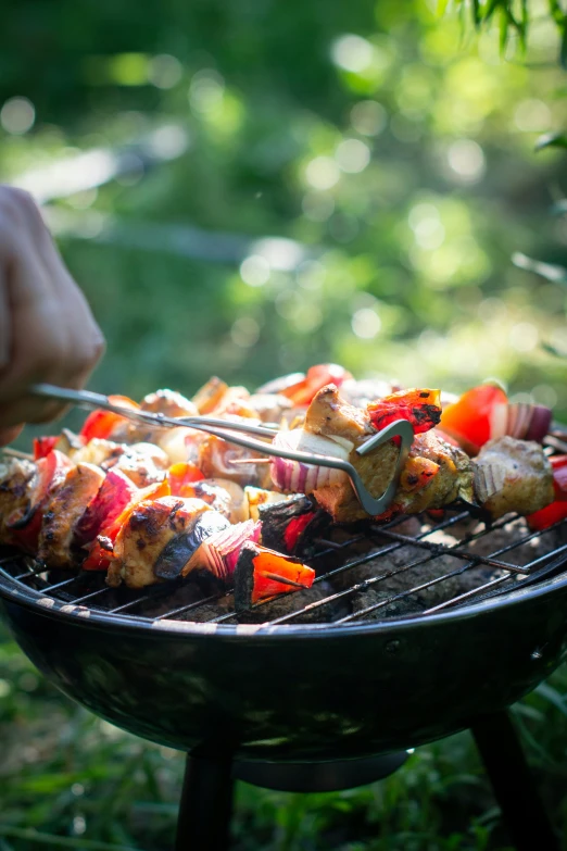 someone cooking food on the grill outdoors