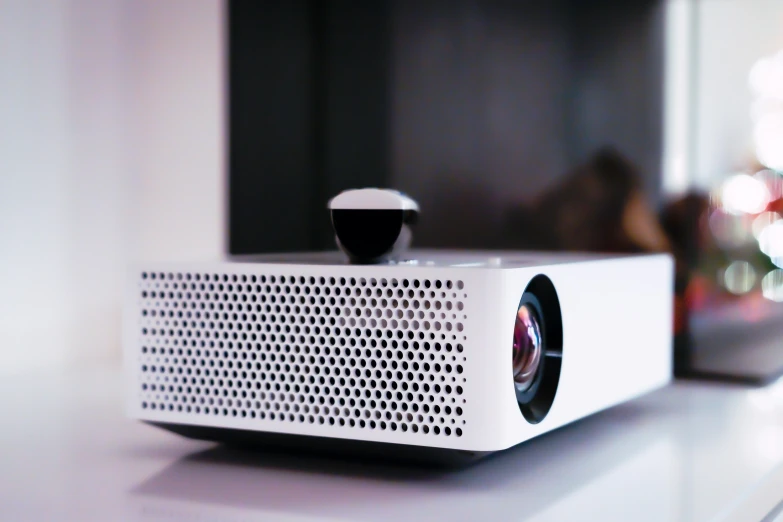 a small white projector sitting on top of a table