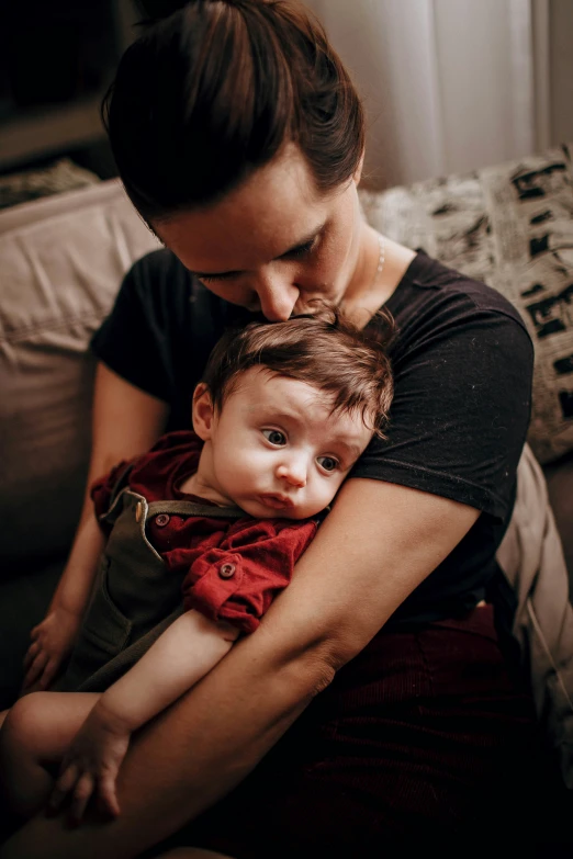 a woman holding a child and hugging them