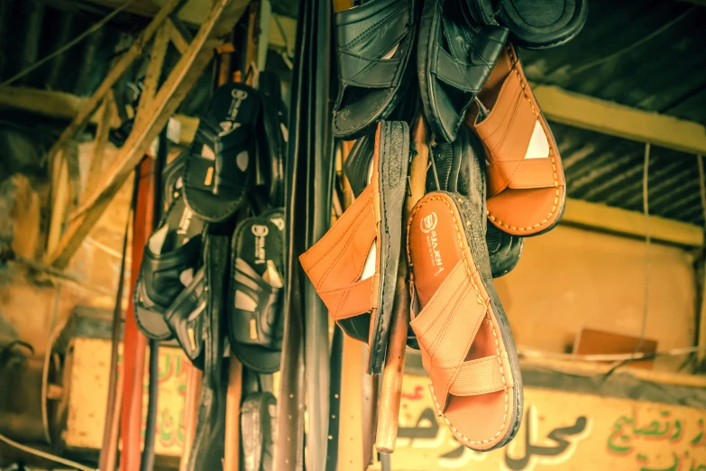 there are sandals hanging outside of a stall