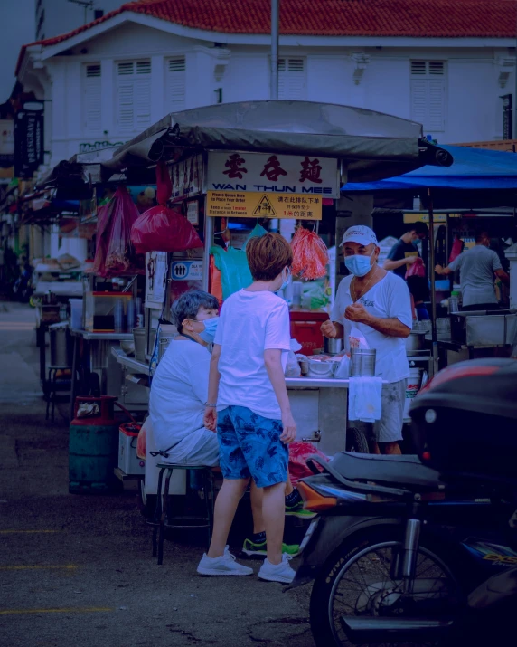 people shop in a busy market place in front of a building