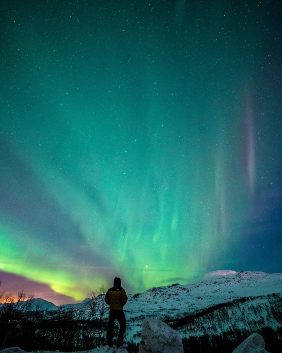 a man standing on the snow in the middle of an icy landscape