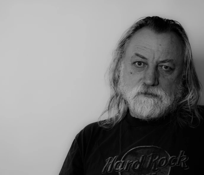 a black and white po of a man with long hair