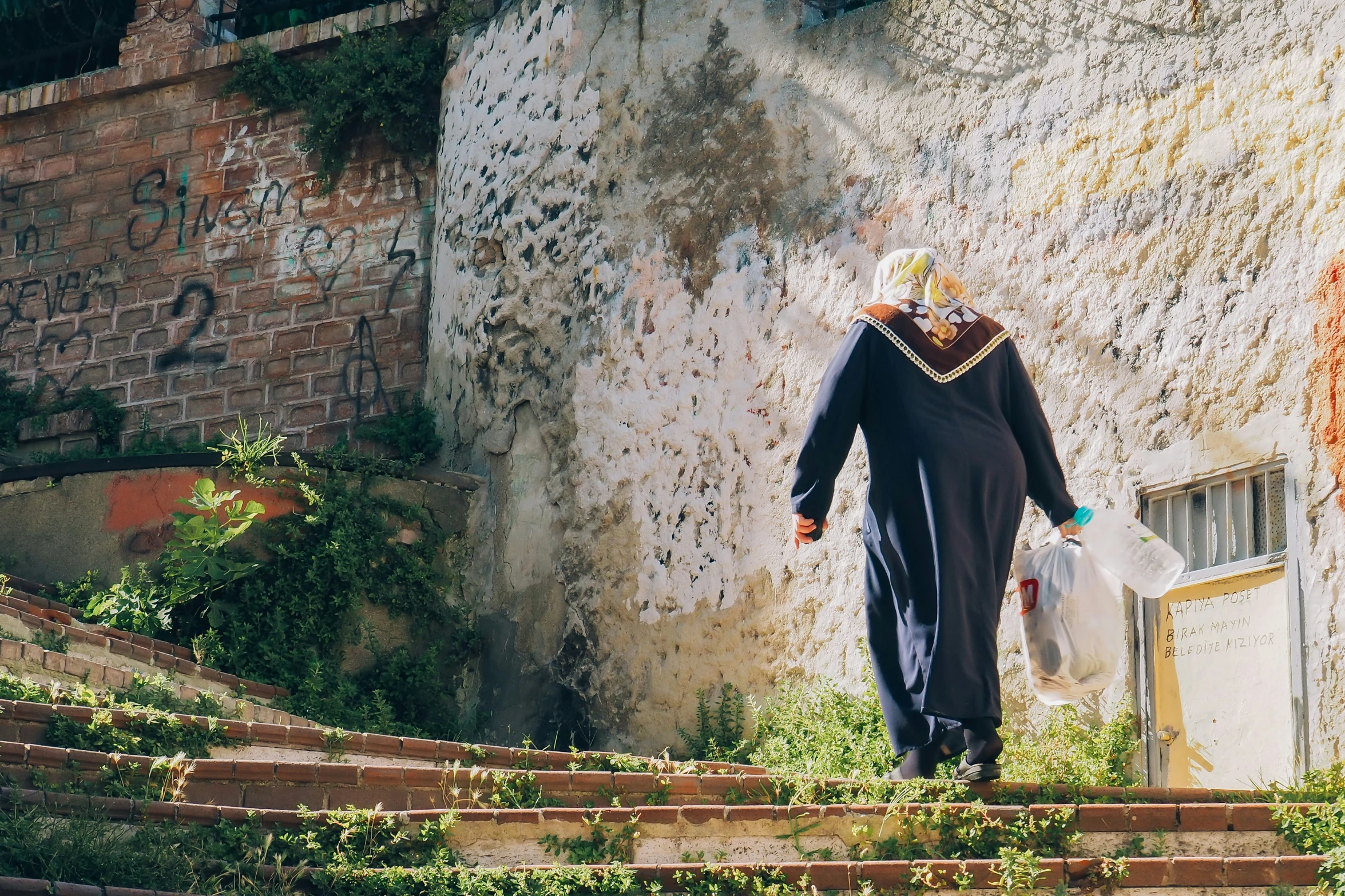 the woman is walking down a set of steps