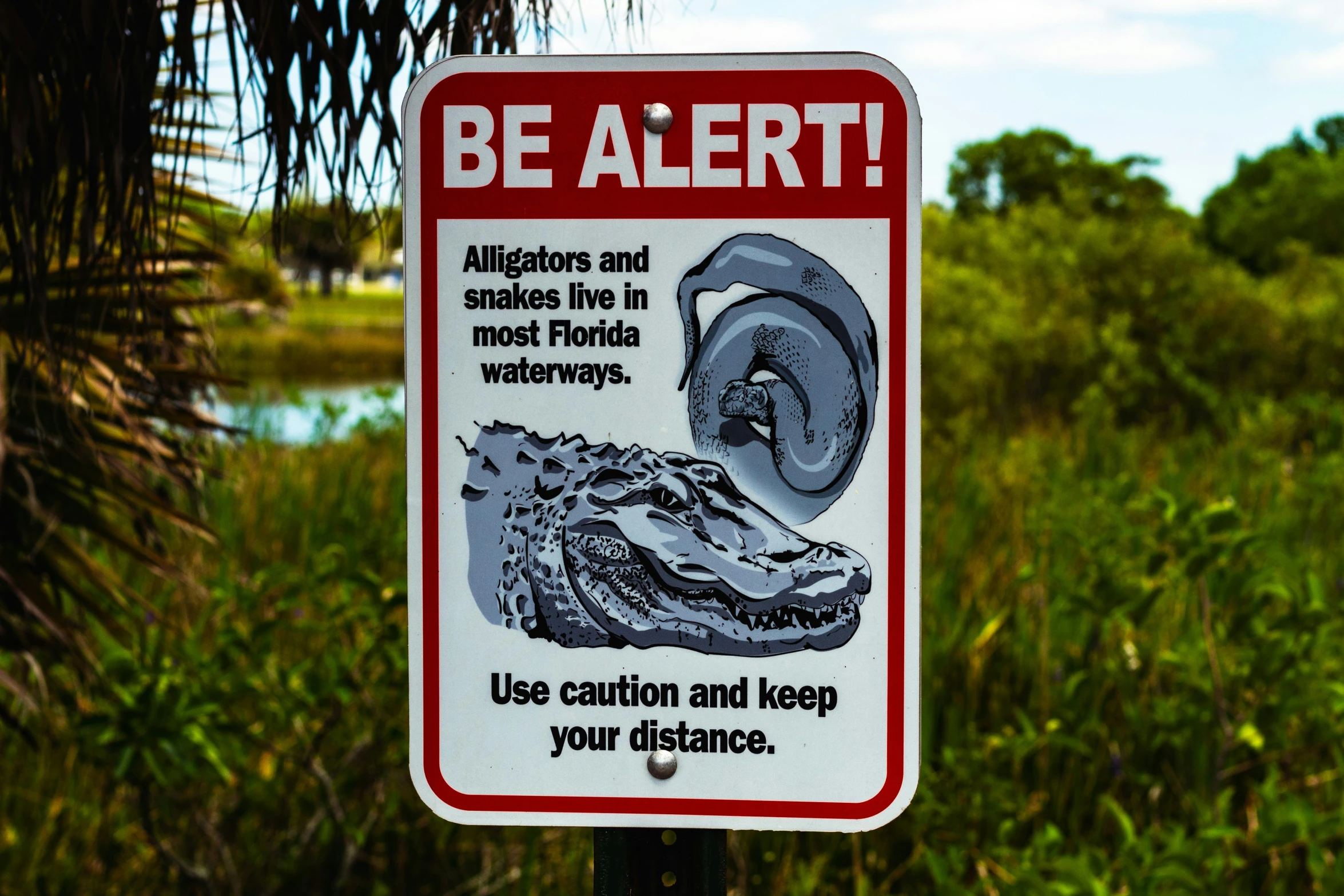 a sign that is posted in front of some grass