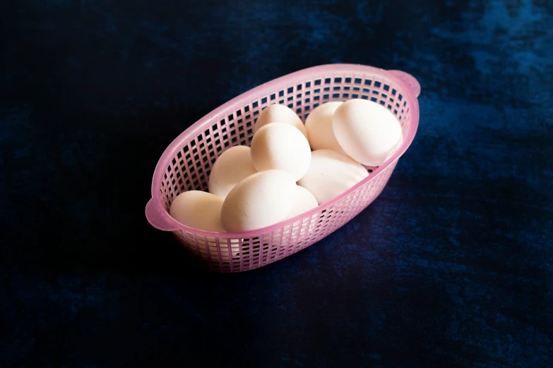 the plastic basket has several eggs inside of it