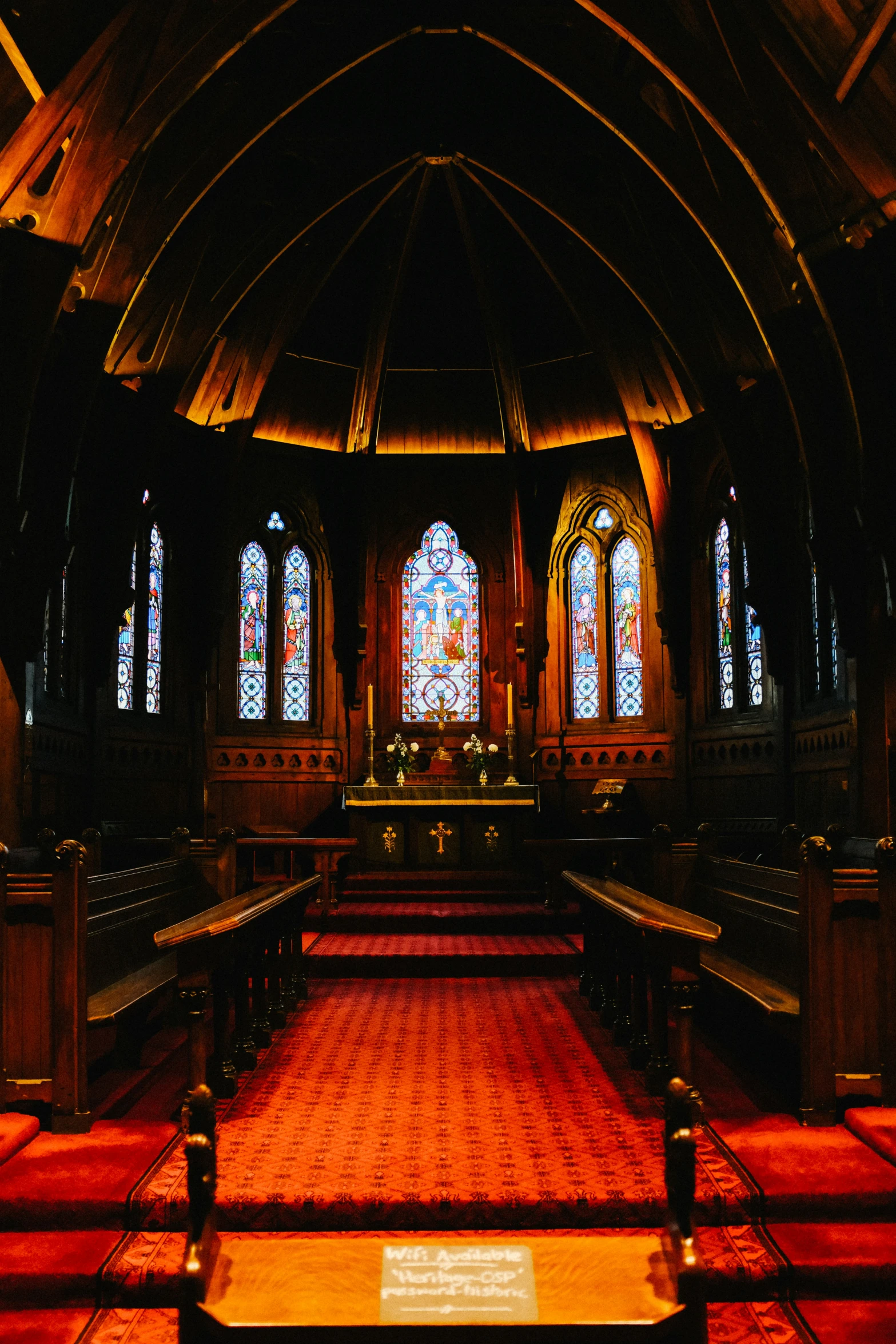 the inside of a church has red carpet on it