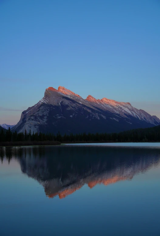 a mountain is reflected in the lake