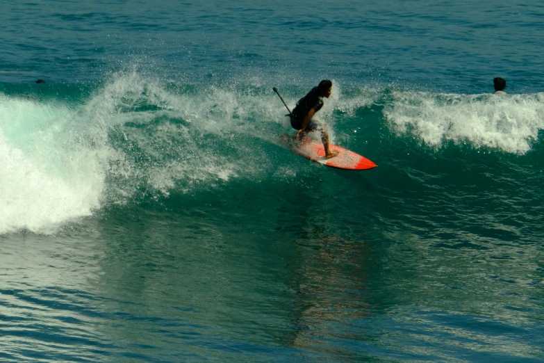 a surfer is riding a surfboard under the wave