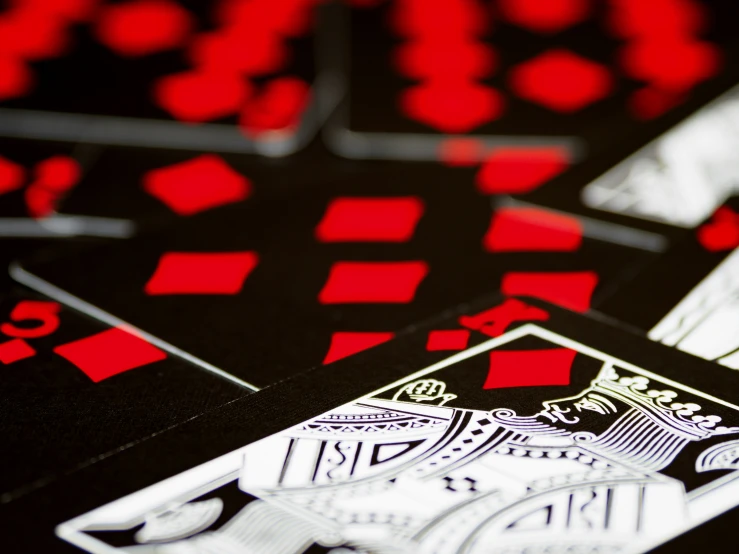 black playing cards with red checkers and white checker symbols