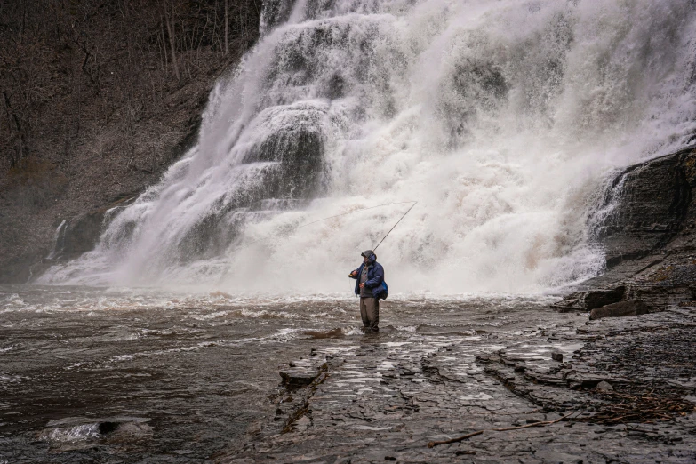 man fishing for rainbow in multwater under falls