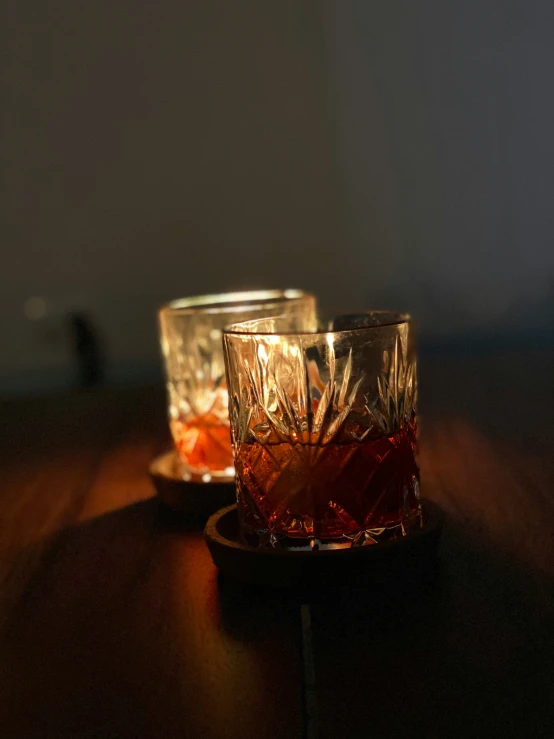 a glass with a drink in it on a wooden table