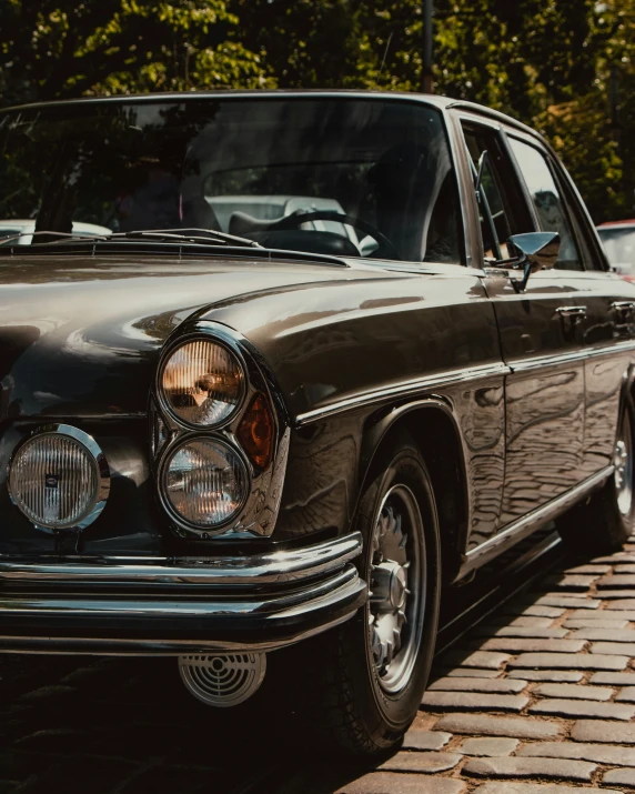 a black vintage car sitting in front of a building