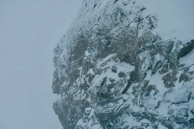 a skier is standing near some snow covered mountains