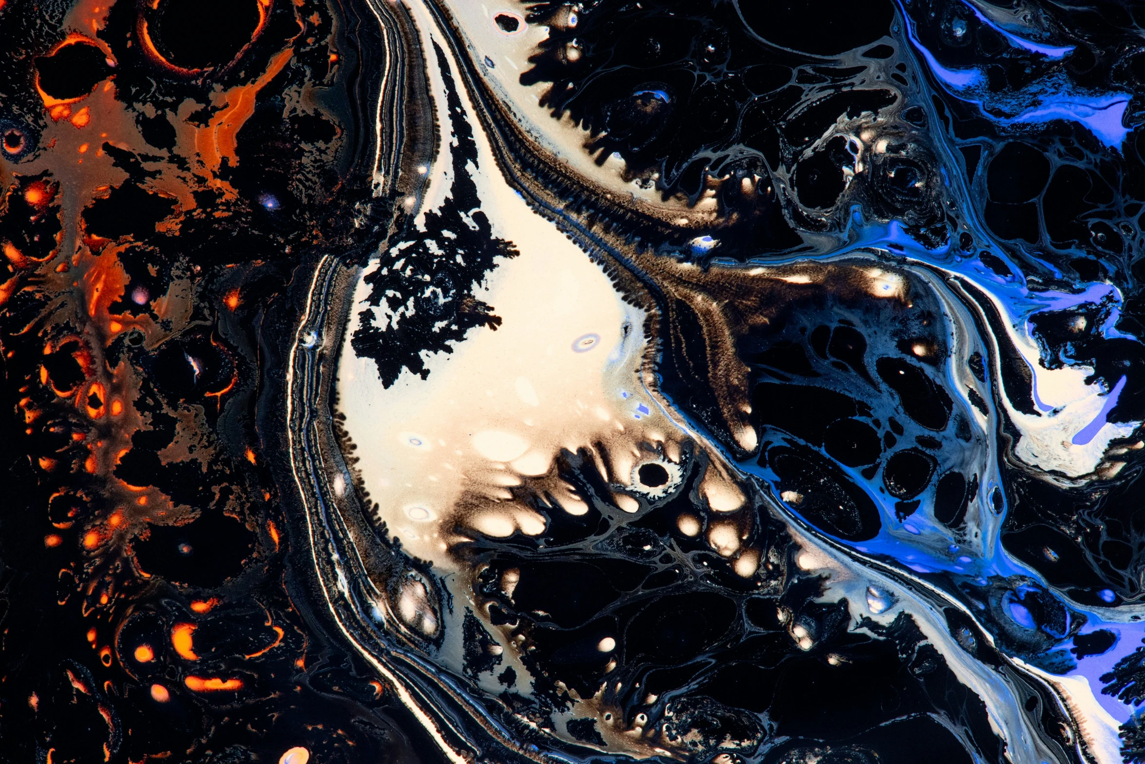 a close - up of abstract paint with orange and black streaks