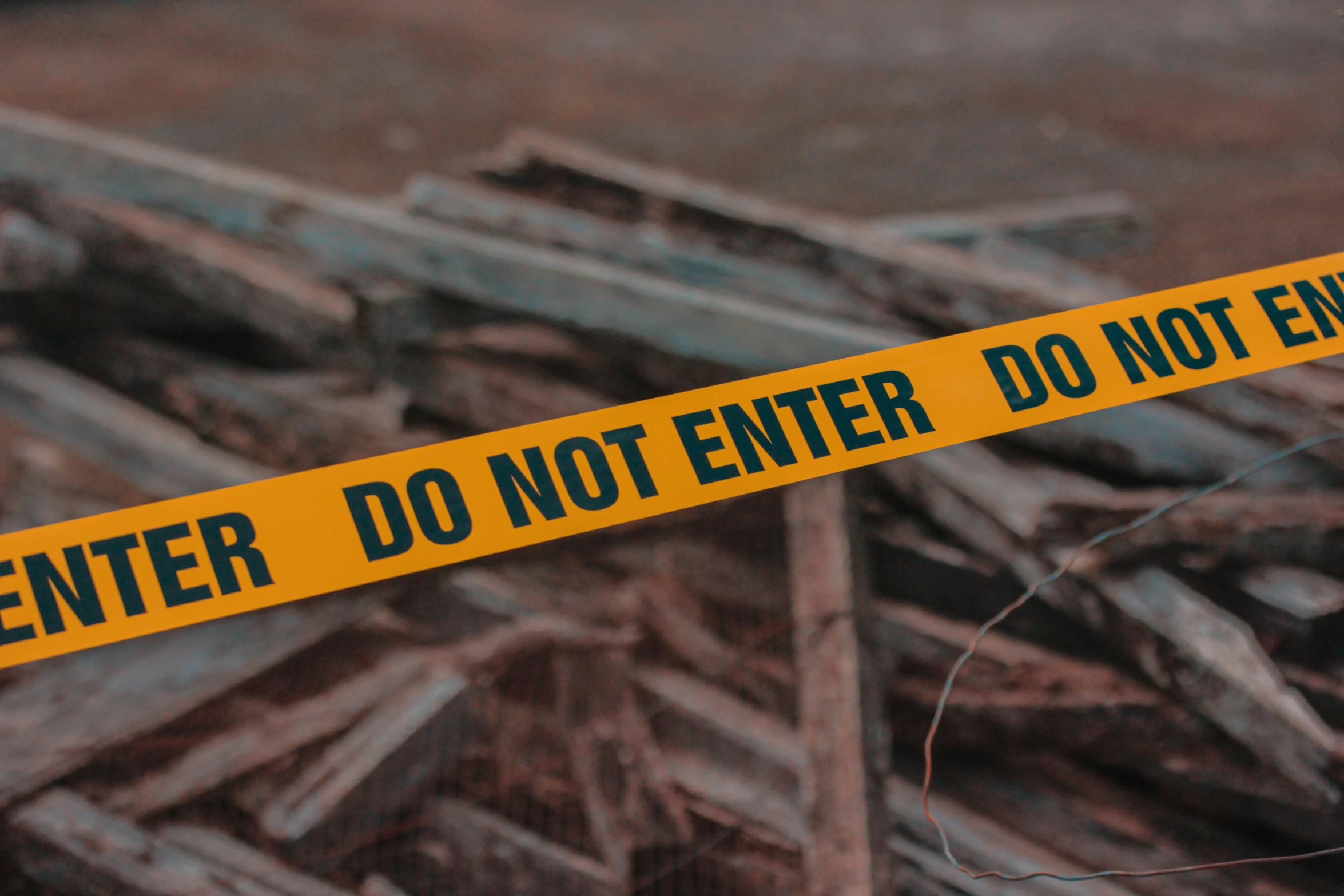 a yellow caution sign sitting on top of a pile of debris