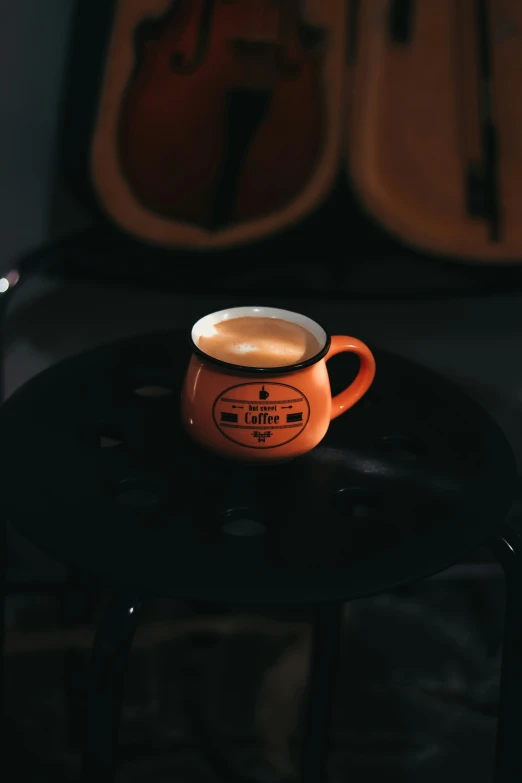 a cup of coffee sits on top of a table