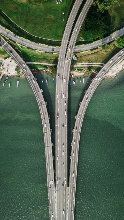 a two - lane highway intersecting in the middle of a body of water