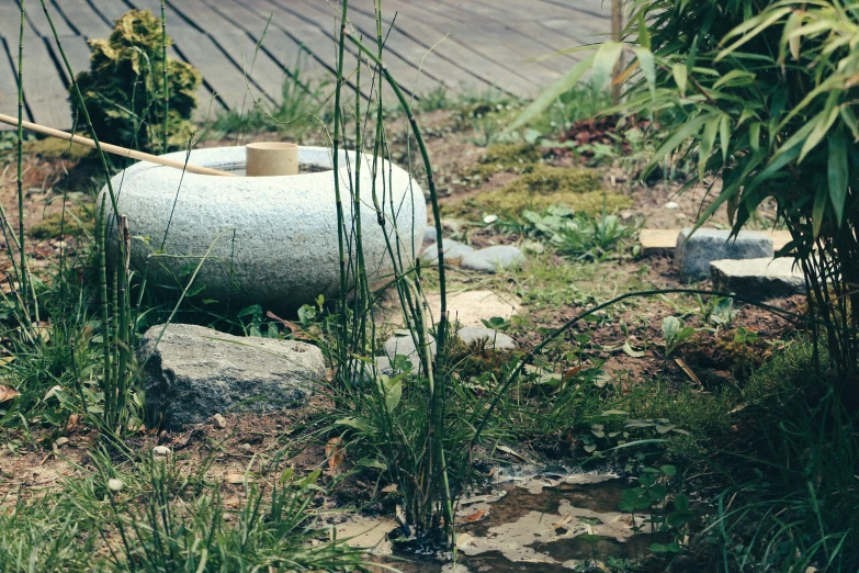 a large water tank in the middle of some grass