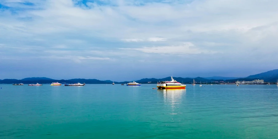 a number of boats in the water near one another