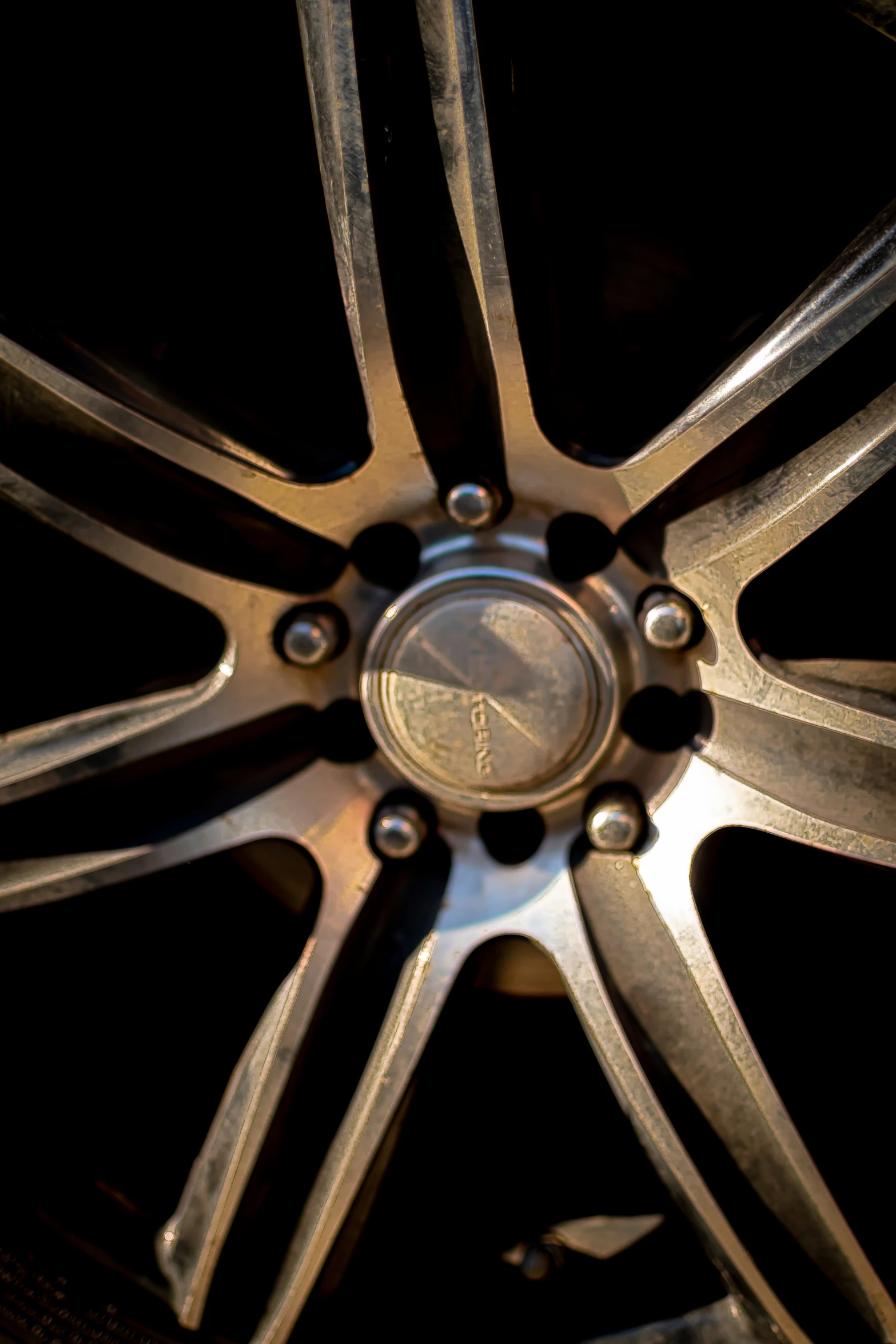 a wheel on a black sports car at night