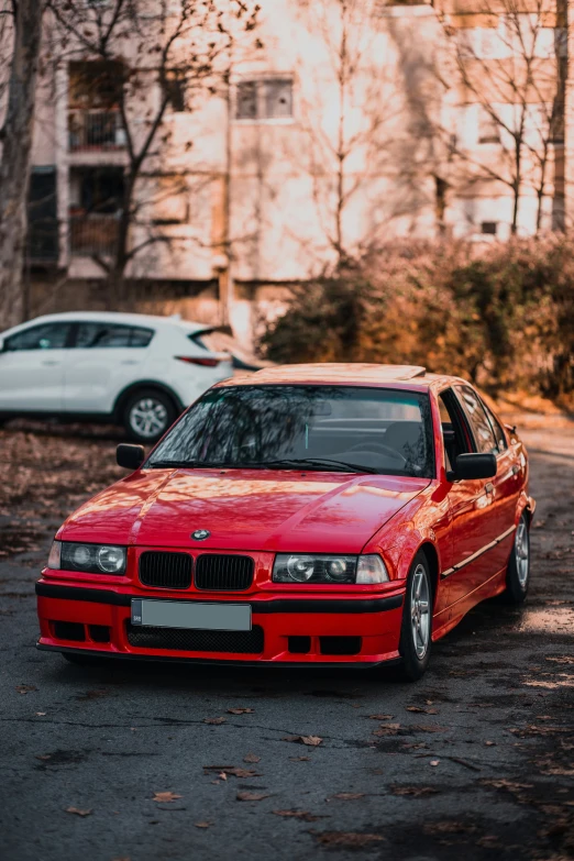 the car is parked in the driveway by the bushes