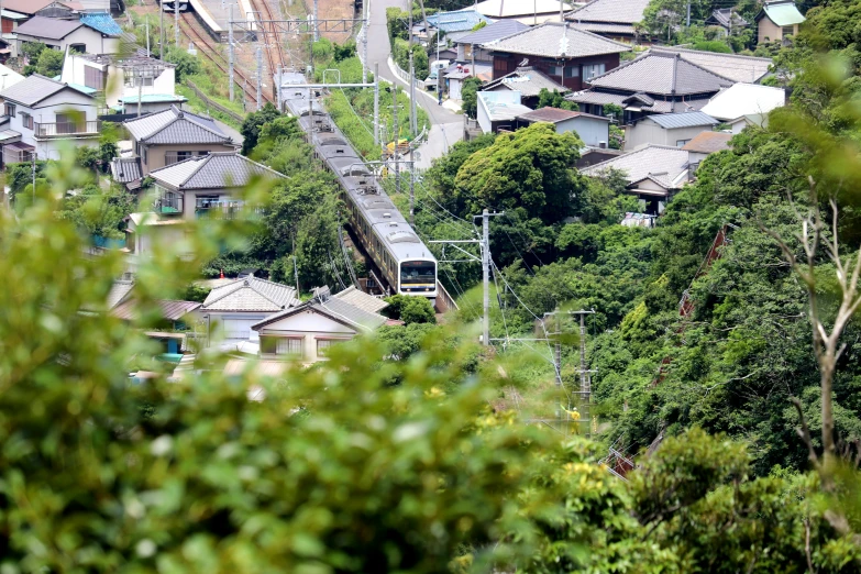 a train passing through a small town by trees