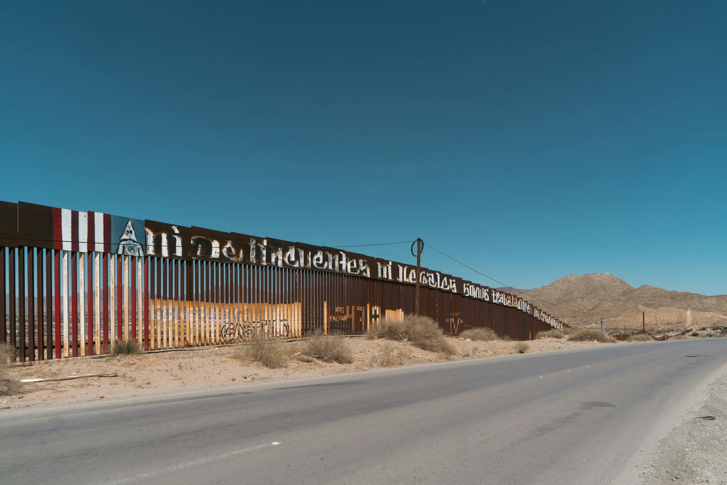 a highway going by a large wall of metal