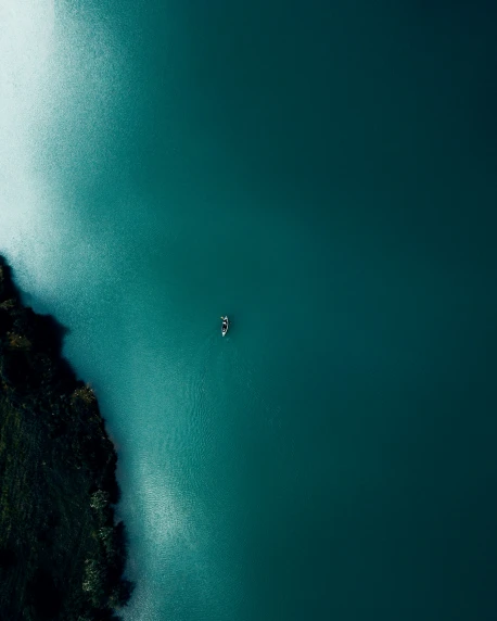 an overhead view of a person paddling in a canoe