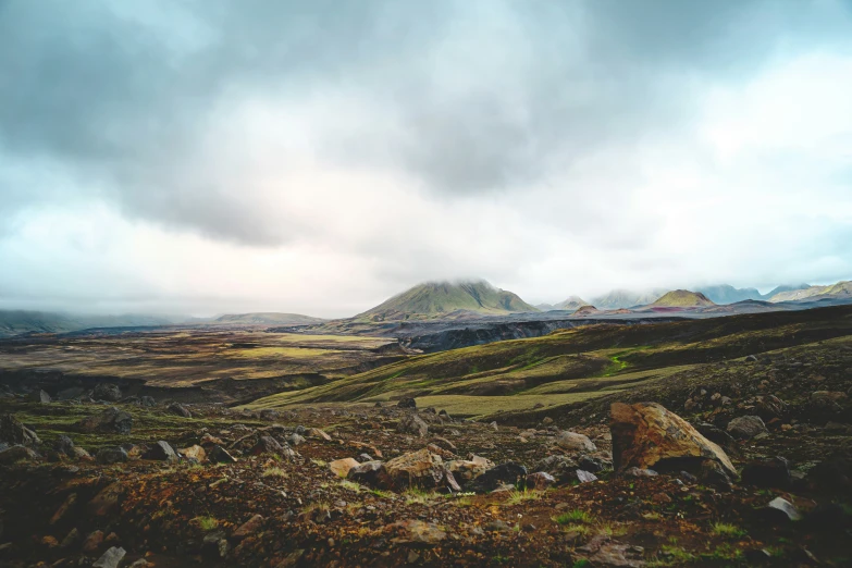 a rocky mountain range with clouds covering the mountains