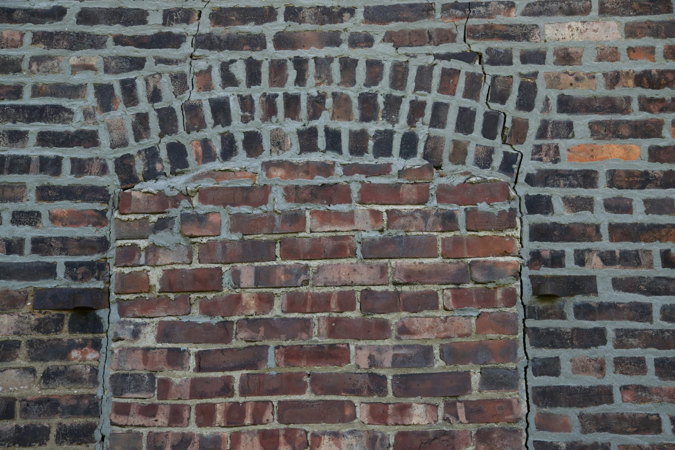 a brick wall with a arch in the middle