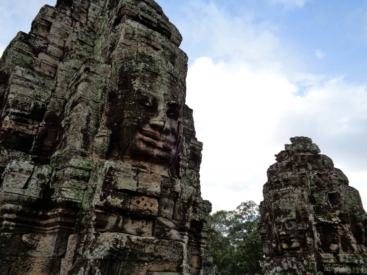 a couple of tall stone buildings next to each other