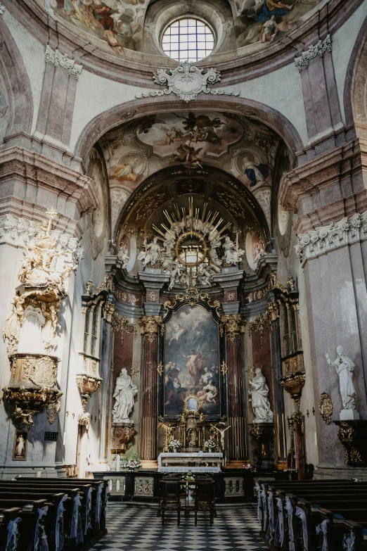 a church with statues on the wall and paintings on the wall