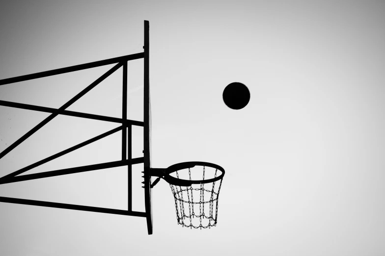 a silhouette of a basketball hoop and a basketball net