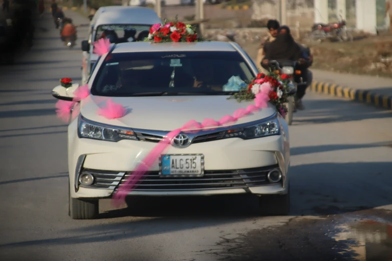 a flower adorned car on the road