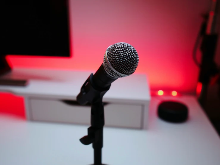 a microphone on a desk near a monitor