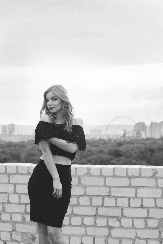 a woman is standing in front of a wall