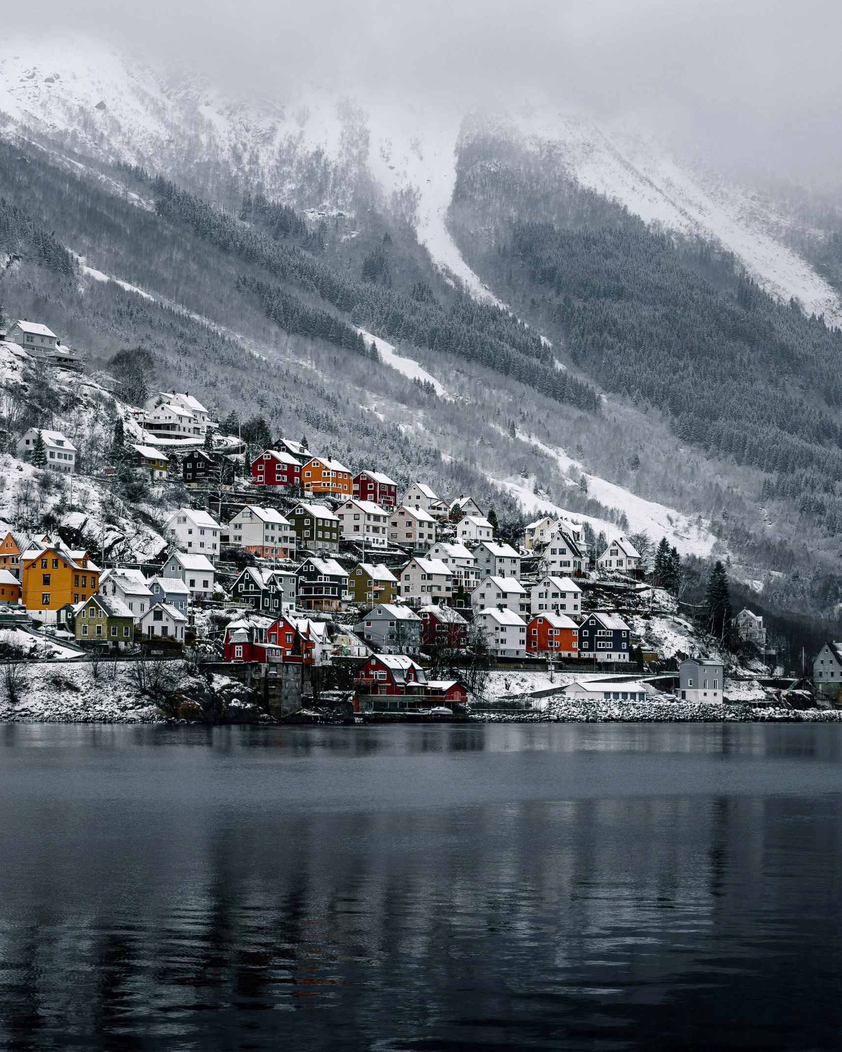 a mountain side town is in the snow