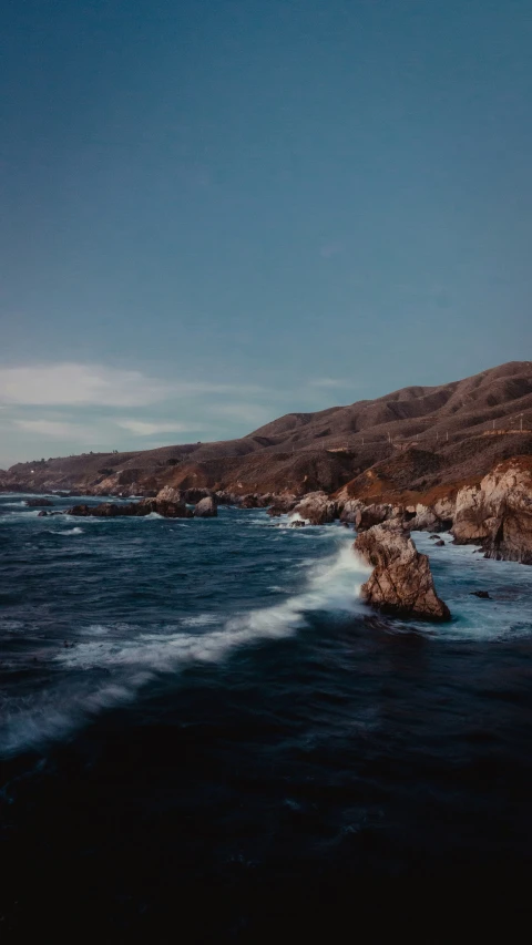 the coastline with many small waves in the ocean