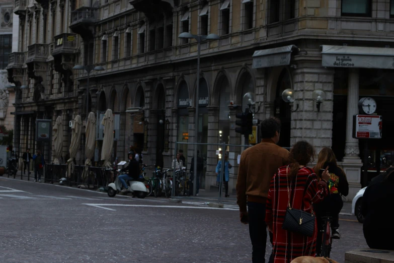 a man and woman are walking down the street