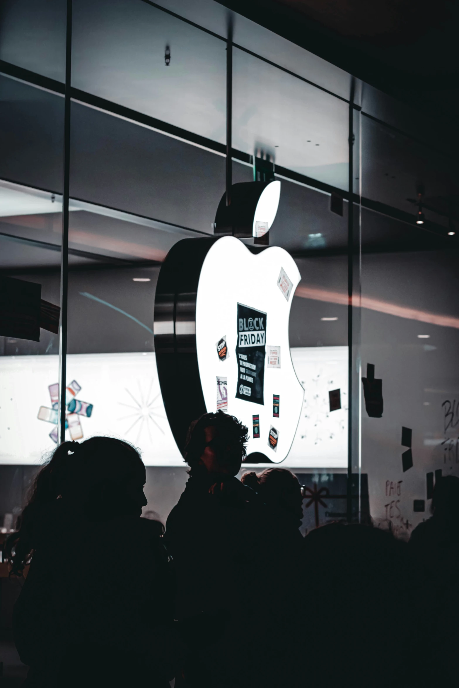 a display in a store window with the apple logo projected